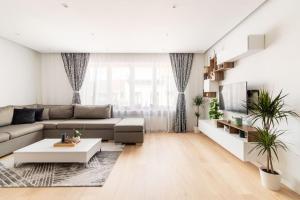 a living room with a couch and a table at European heart 2-bedroom flat. in Brussels