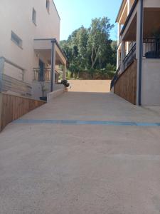 an empty parking lot between two buildings at Hôtel Casa Mea in Bastia