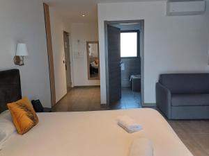 a living room with a bed and a couch at Hôtel Casa Mea in Bastia