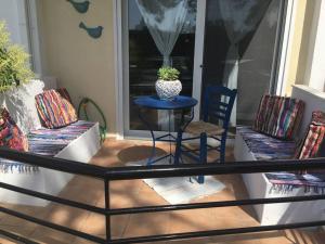 a patio with a table and chairs on a porch at Hara's House 1 in Gerakini