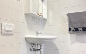 a white bathroom with a sink and a mirror at TerraMar Apartments in Baška Voda +70 photos