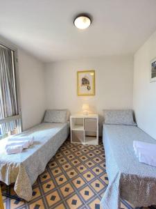 a room with two beds and a table in it at Villetta Cortona in Marina di Pietrasanta