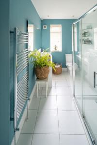 baño con paredes azules y suelo de baldosa blanca en Luxurious Family Townhouse 50m from the Beach, en Brighton & Hove