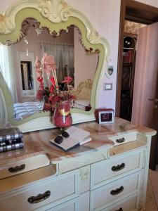 a dresser with a large mirror on top of it at Villa Rosa in SantʼElia