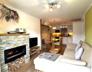 a living room with a couch and a fireplace at Ferienwohnung-Königsschlösser in Füssen