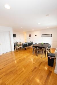 a living room with a table and a couch at Pristine 2-Bed Apt with Skyline Views - mins to NYC in Union City