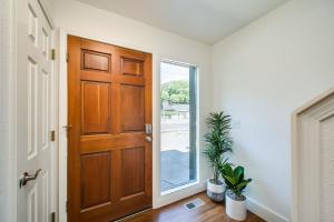 a hallway with a wooden door and a window at Come stay at the Elm Grove Elegance Irene! in Boise