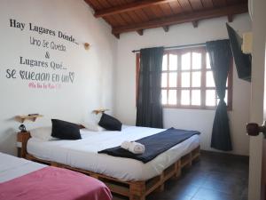 Postel nebo postele na pokoji v ubytování Casa Hostal La Vie en Rose