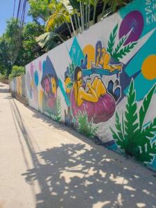 a wall with a mural on the side of it at Lama Beach Villa in An Bang