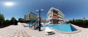 a resort with a swimming pool and a building at Hotel Zaara in Sunny Beach