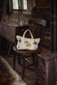 a white bag sitting on a chair next to a desk at The shepherds hut at abberley glamping in Abberley