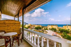 a balcony with a table and chairs and a view of the ocean at Irene Apartments in Karpathos