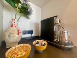 a kitchen counter with a coffee maker and a vase at Le Bluebay - Luxurious 2 bedrooms seaview swimming pool carpark in Cannes