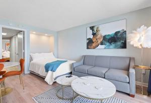 a living room with a couch and a bed at Tranquil Palms-Oceanfront Condo in Myrtle Beach
