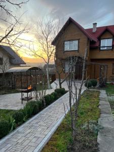 a house with a fire pit in the yard at Марічка Marichka in Vorokhta