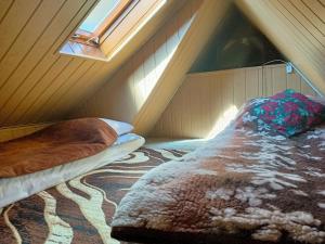 A bed or beds in a room at Pokój pod lasem u Ewki