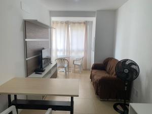 a living room with a couch and a table at Novo apto com garagem no centro de Passo Fundo RS in Passo Fundo
