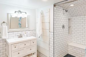 a white bathroom with a sink and a shower at Narrow Gauge Nook in Durango