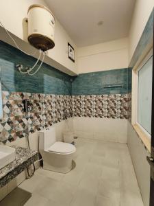 a bathroom with a toilet and a sink at maharaja resort in Candolim