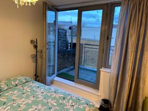 a bedroom with a bed and a window with a view at Overton in London