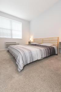 a bedroom with a large bed and a window at Modern & Cozy 2 - Bedroom gem mins from NYC in Jersey City