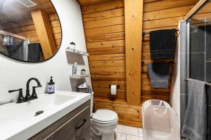 a bathroom with a toilet and a mirror at Grand Canyon Cabin! One hour and 10 minutes to the South Entrance! in Williams