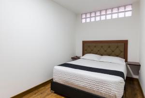 Ένα ή περισσότερα κρεβάτια σε δωμάτιο στο Hotel Casa Botero 104