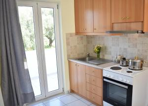 a kitchen with a stove top oven next to a window at Elounda Holidays Argyro in Elounda