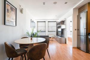 a kitchen and living room with a table and chairs at apartamento en plaza de españa in Madrid