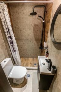 a bathroom with a toilet and a sink and a shower at Happiness studio with terrace. in Thessaloniki +12 photos