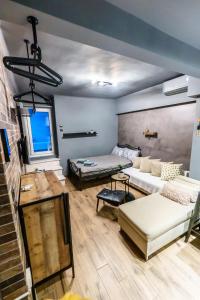 a living room with a couch and a bed at Happiness studio with terrace. in Thessaloniki