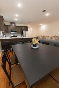 a kitchen with a black table with a plant on it at Elegant Modern 3-Bed Apt near NYC in Jersey City