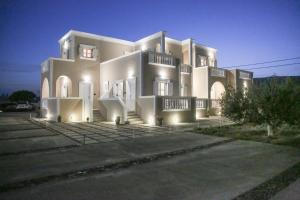 a large white building with lights on it at Pension St.George Rooms & Studios in Perivolos