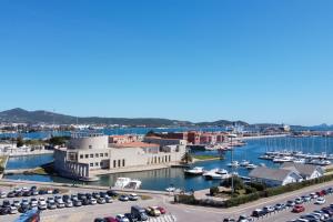 a marina with cars parked in a parking lot at Casa Smeralda Olbia in Olbia