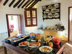 a table with many bowls of food on it at Casa do Peso in Crato