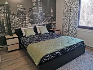 a bedroom with a large bed with a view of the city at Boho Apart Ututie in Kotka