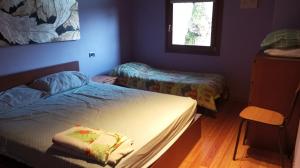 a small room with two beds and a window at agriturismo il riccio in Cedegolo