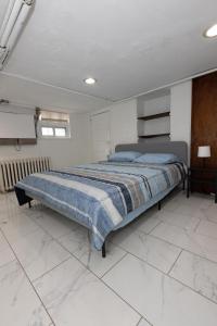 um quarto com uma cama num quarto branco em Chic 3BR Hideaway mins from NYC em Jersey City