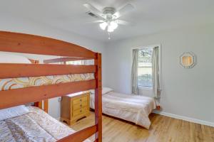 a bedroom with two bunk beds and a ceiling fan at The Old Parsonage Pindall House with Patio! 