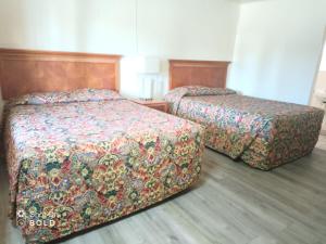 A bed or beds in a room at Border Motel