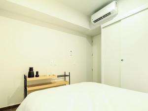1 dormitorio blanco con 1 cama y aire acondicionado en Tribu Lafayette, en Guadalajara