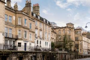 a row of buildings in front of a street at Beautiful apartment in Bath in Bath +1 photo