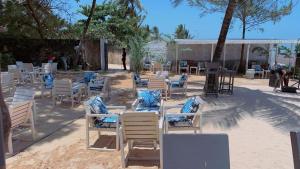 a group of chairs and tables on the beach at Silver Rock Hotel in Malindi