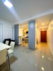 Luminoso departamento en Villa Crespo في بوينس آيرس: غرفة مع طاولة وكراسي ومطبخ