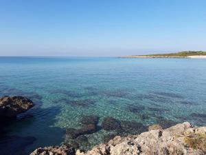 a large body of water with rocks and reefs at Casa Vostra in Taranto