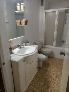 a bathroom with a sink and a toilet and a shower at El Molino Buñol Apartamento in Buñol +10 photos