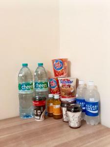 a refrigerator with bottles of water and other food items at Kelud Syariah Guesthouse in Blitar