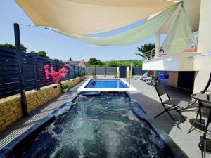 a swimming pool in a backyard with an umbrella at Nice apartment -with new private pool in Stari Grad