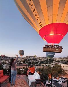 a group of people flying a hot air balloon at Karadut Cave Hotel in Göreme