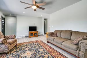 a living room with a couch and a flat screen tv at Wausau Home with Yard 1 Mi to Granite Peak Ski Area in Wausau